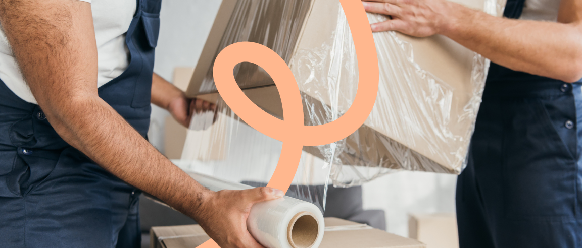 Removal professionals wrapping furniture to protect it during a house move.