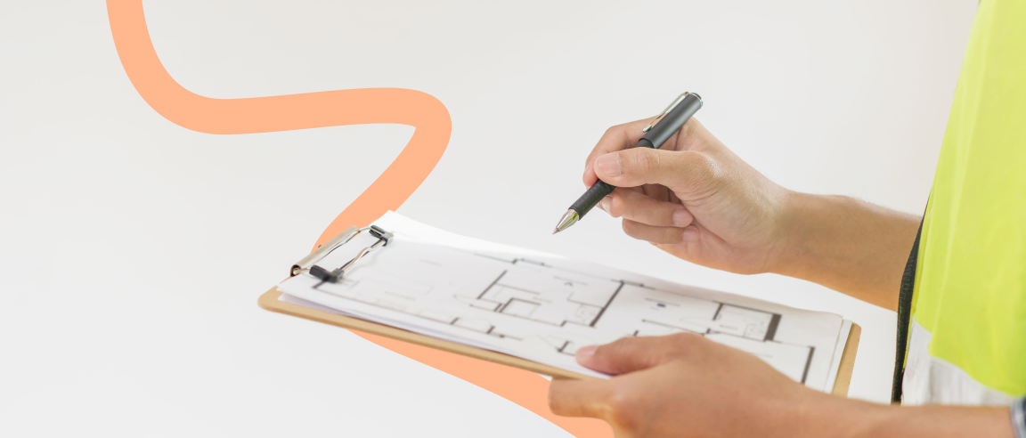 Property surveyor reviewing house plans during a home survey.