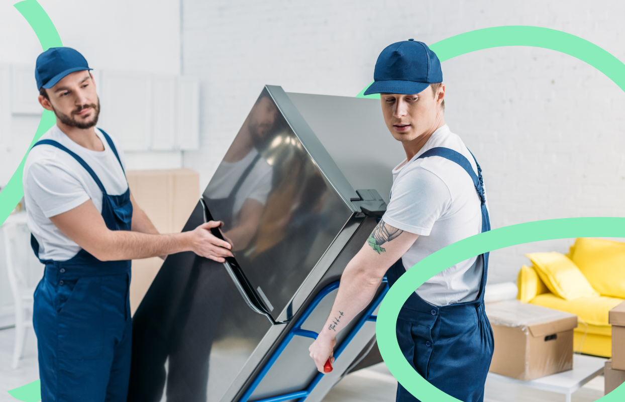 Removal professionals carrying a TV during a house move.